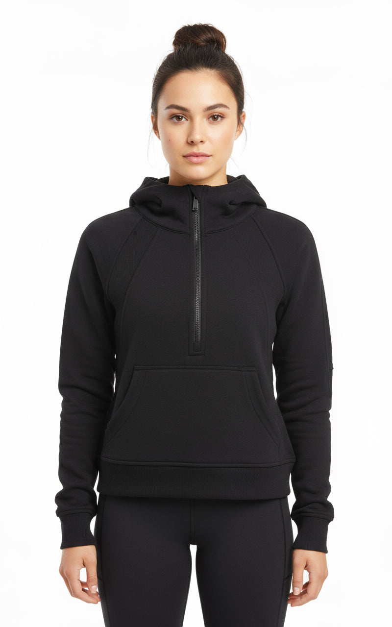 Woman wearing a black hoodie with a quarter zip on a white background