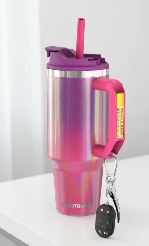 Gradient pink to purple tumbler with a handle and straw on a white surface.