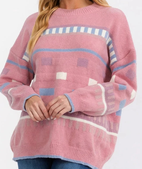 Pink sweater with geometric pattern on a white background