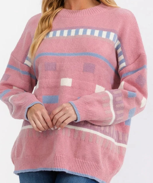 Pink sweater with geometric pattern on a white background