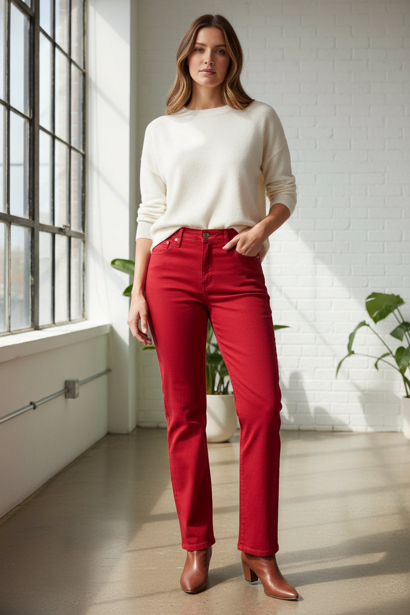 Red jeans hanging on a white background