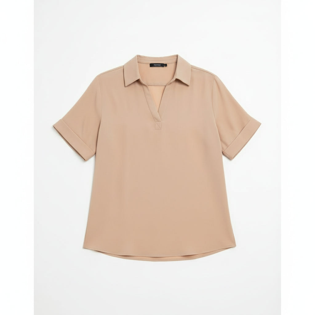 Woman wearing a beige blouse and white pants on a white background