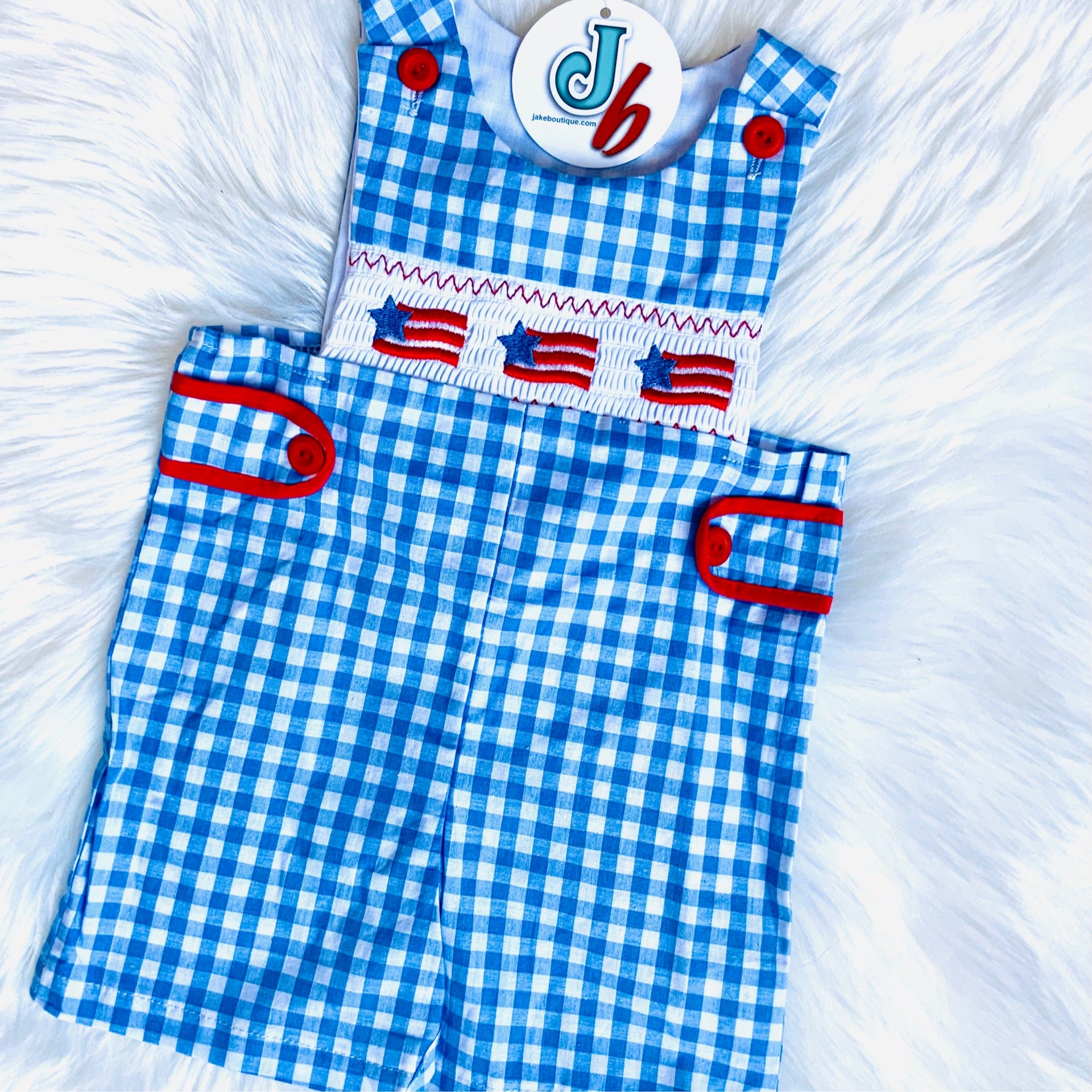 Boys Patriotic Smocked Romper – Blue Gingham One-Piece with American Flag Embroidery & Red Button Accents