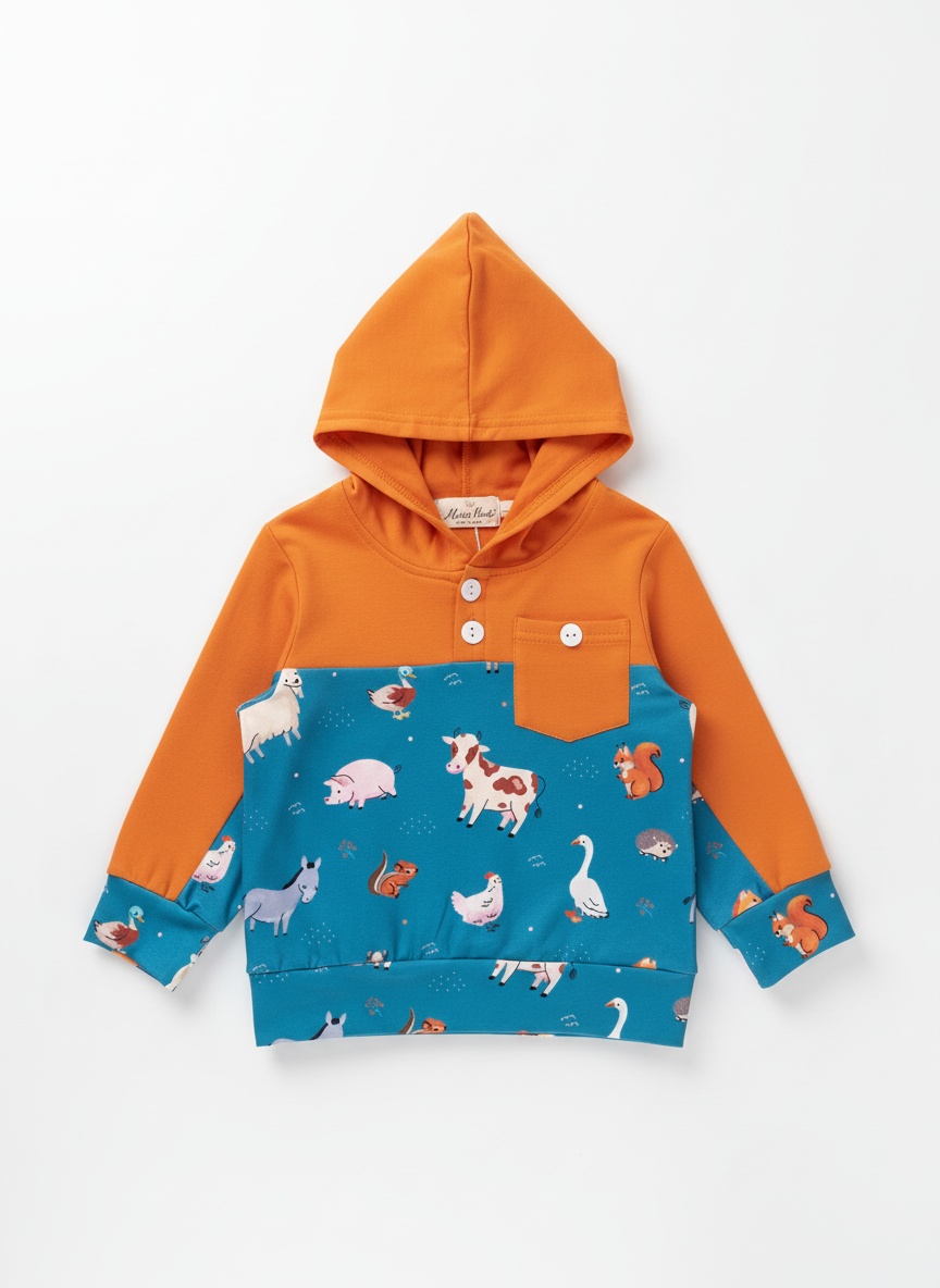Orange hoodie with animal pattern on a wooden surface