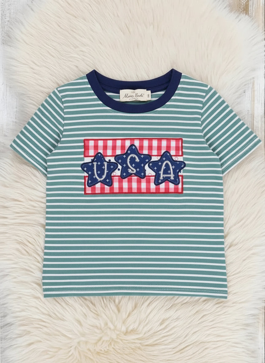 Teal and white striped t-shirt with red and blue graphic on a fluffy white surface